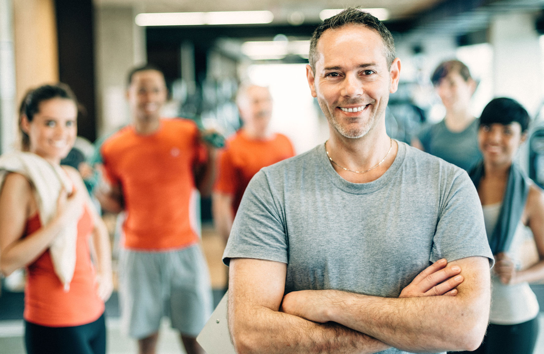 A group of people looking at the camera in a fitness studio