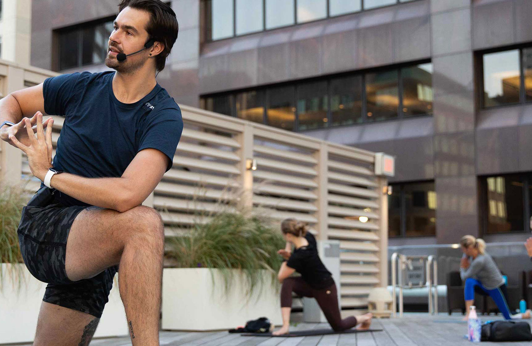 a group of people doing exercise outdoors during COVID