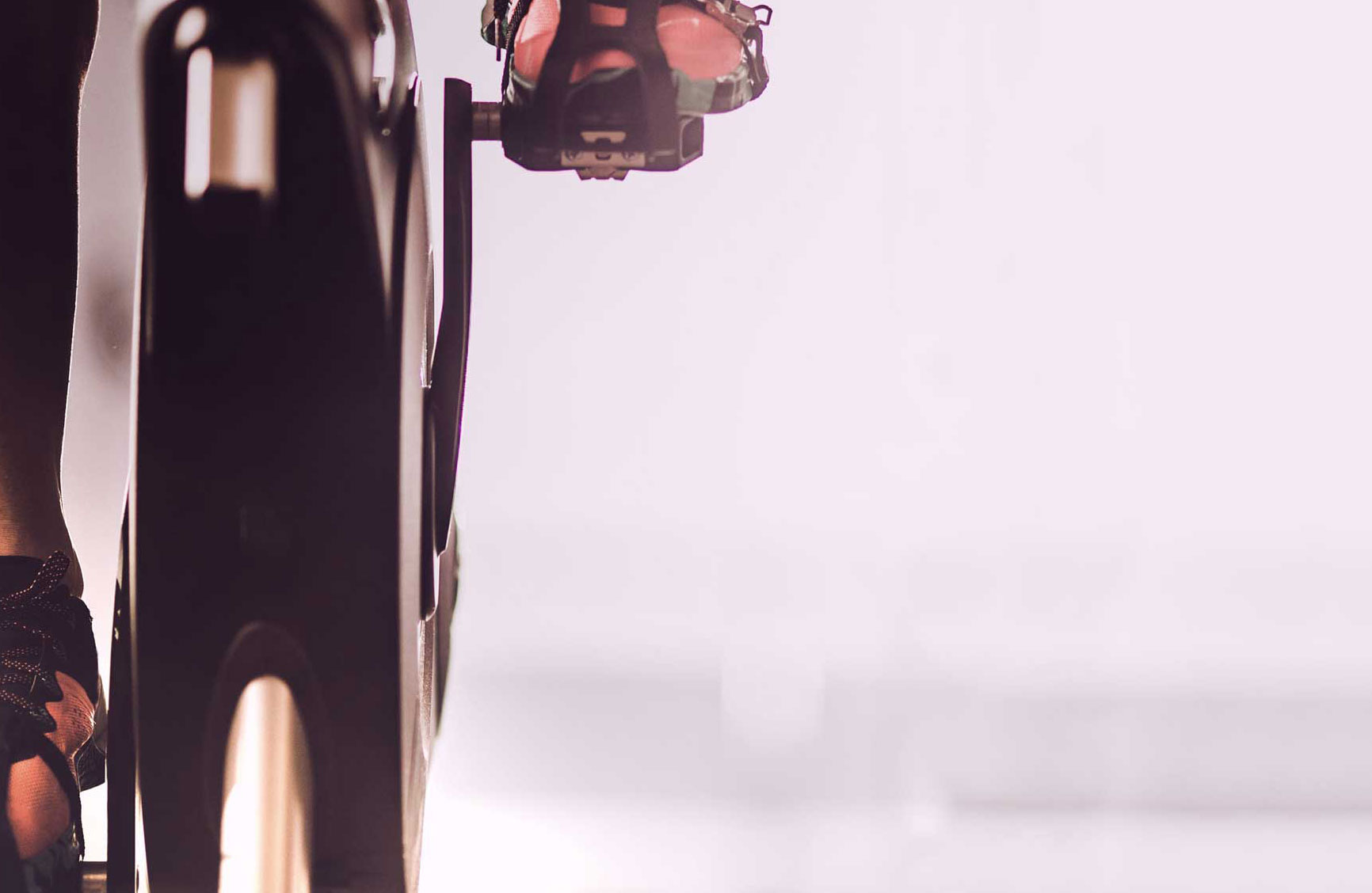 a closeup image of someone's feet cycling on a stationary bike