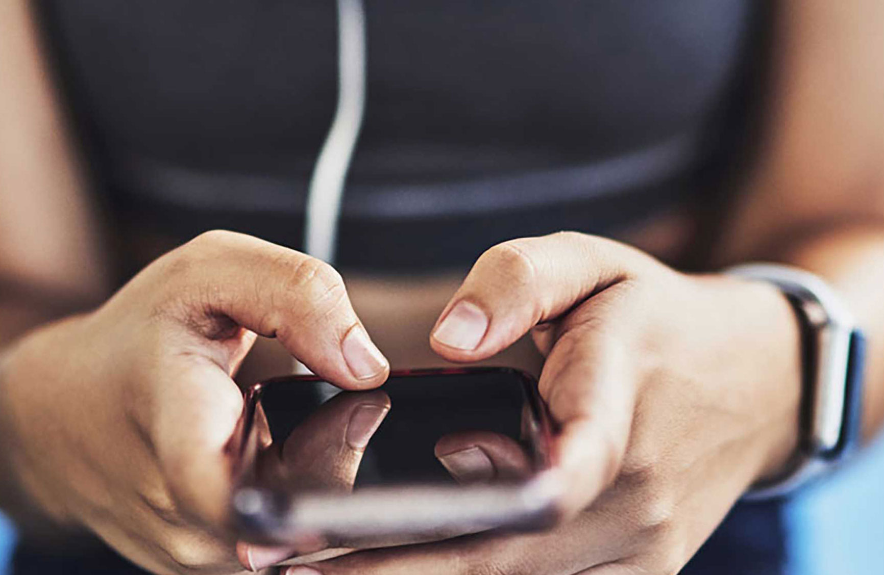 a closeup photo of a girl's hands using a cell phone