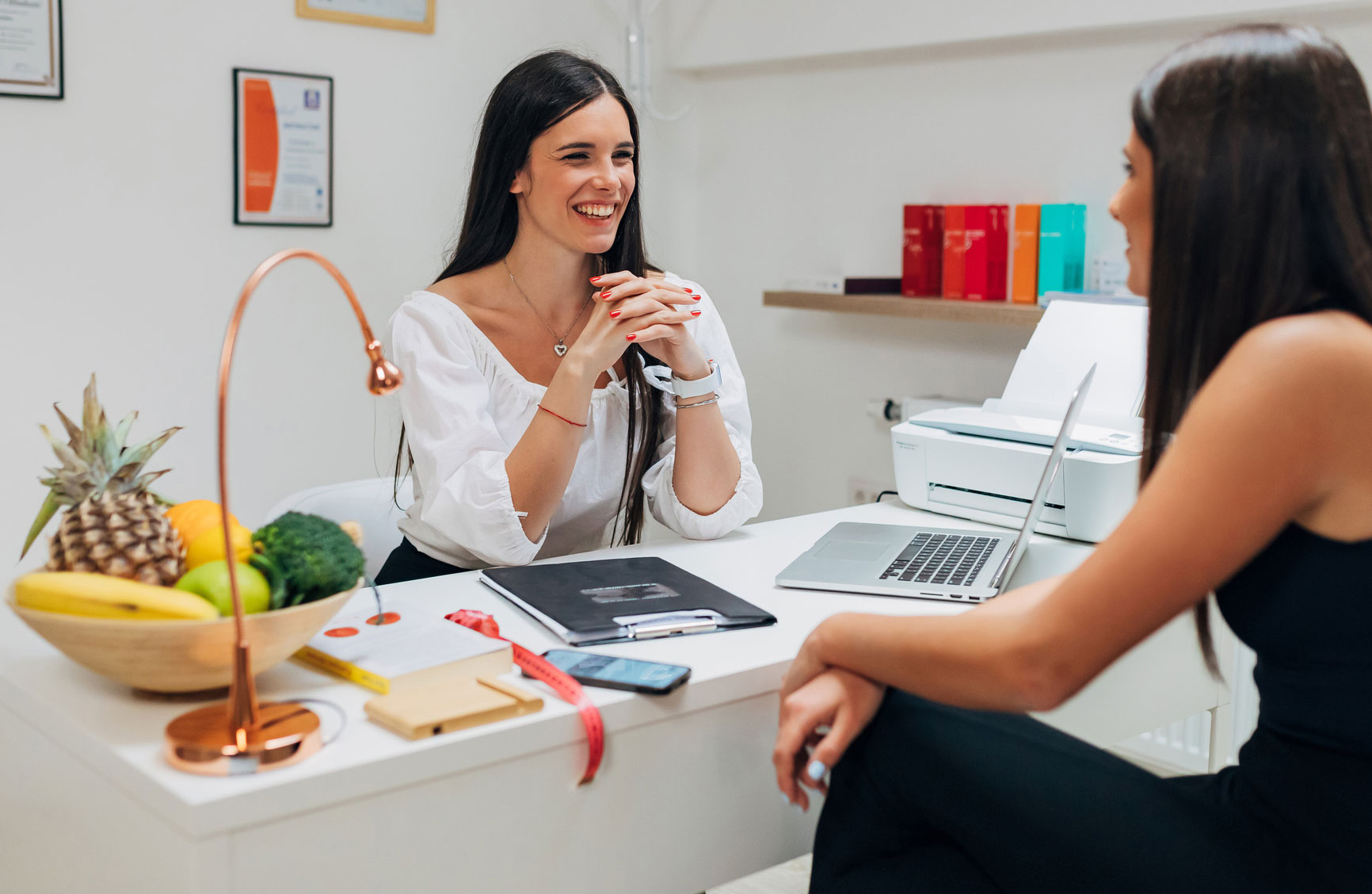 a female wellness coach talking to her client