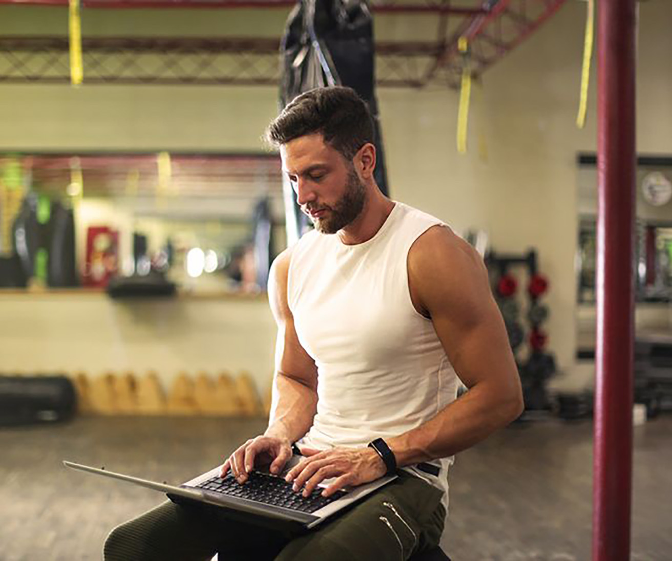 fit man using a computor in a gym