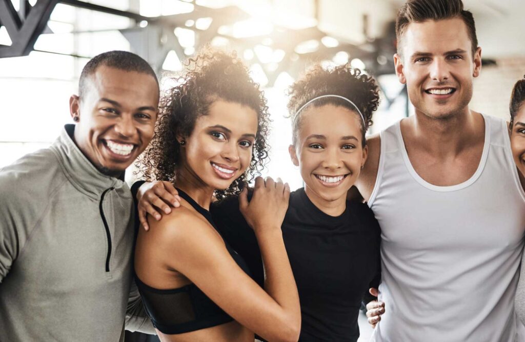 Shot of a group of happy young people working out together in a gym