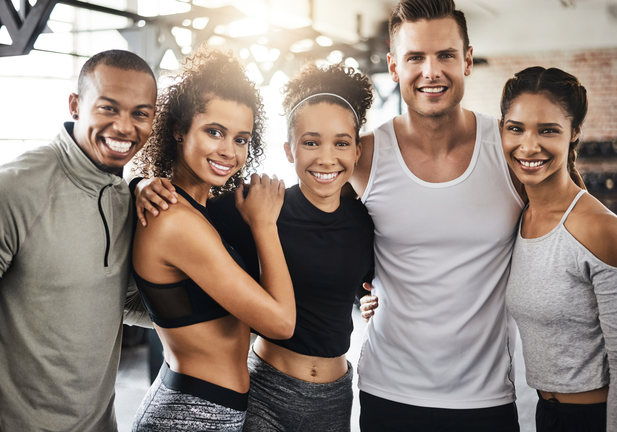 Shot of a group of happy young people working out together in a gym