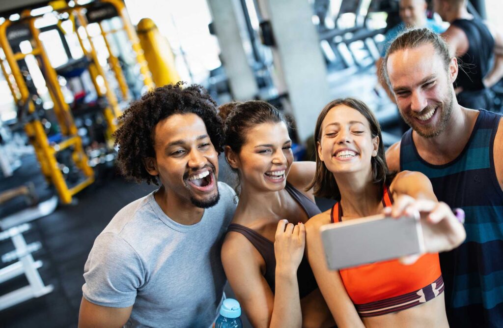 Friends having fun at the gym, making a selfie