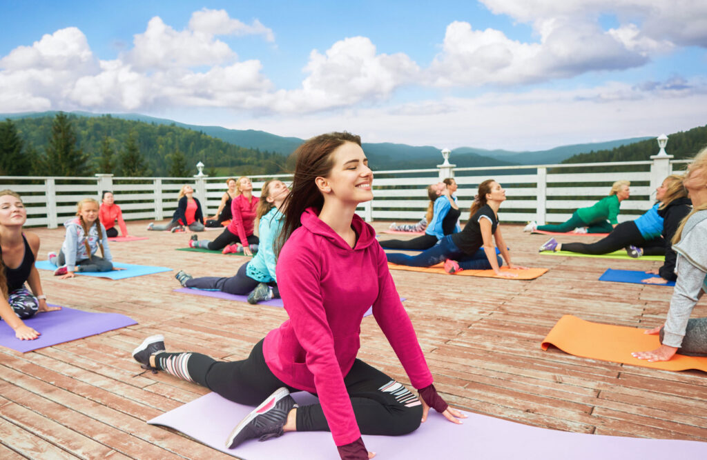 a group of ladies doing yoga outdoors