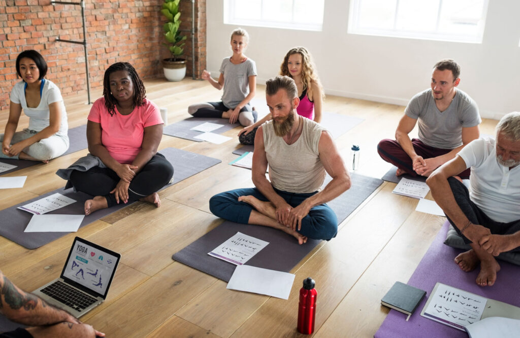 a group of people in a yoga class