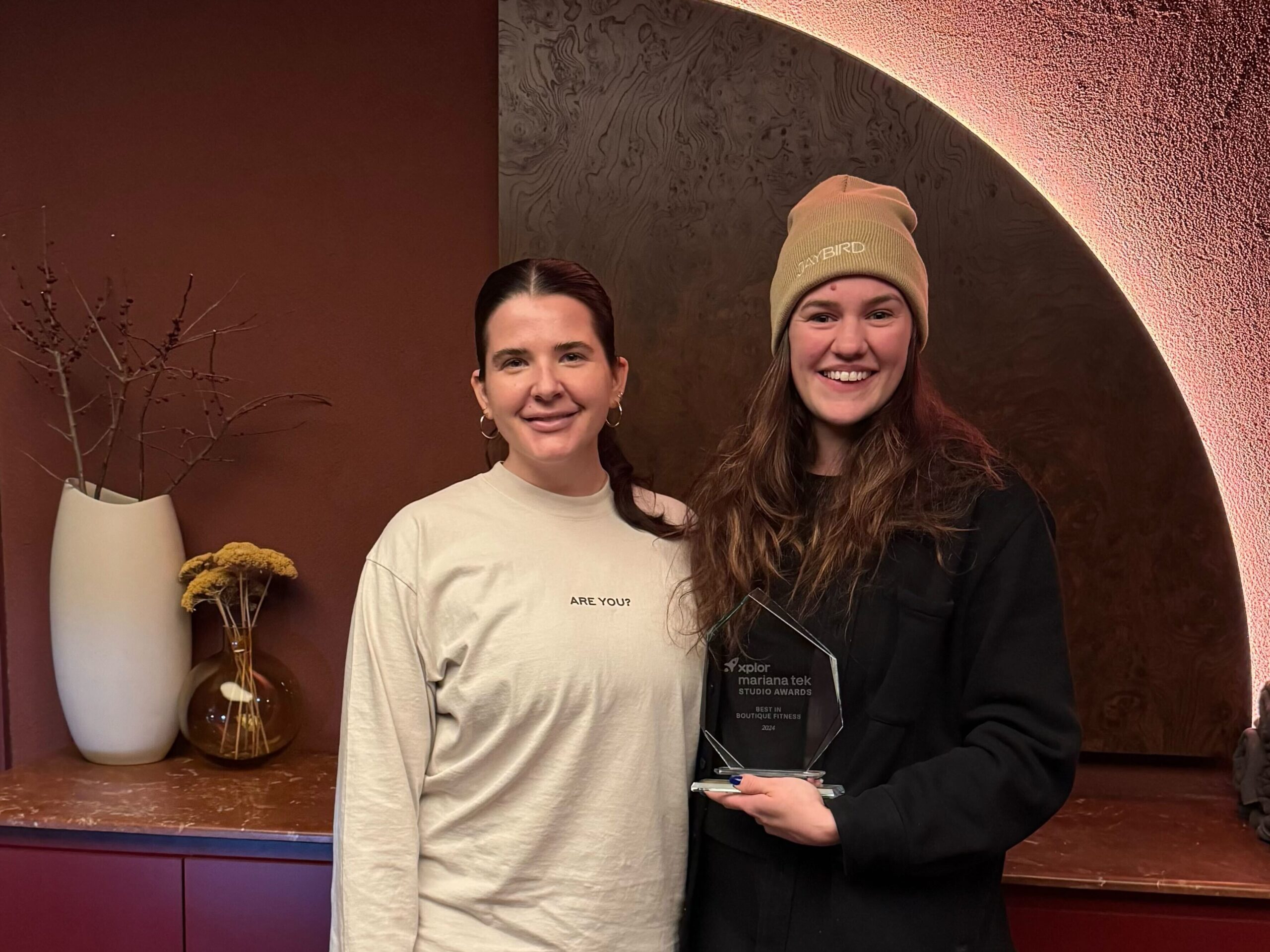 Jaybird co-owners accepting the Mariana Tek Award for Pilates Attendance, celebrating their achievement in studio engagement and client retention